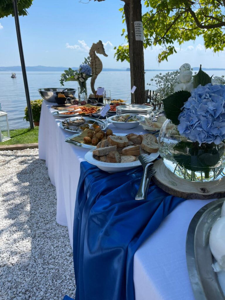 Tavolo imbandito all'aperto con vista sul lago.